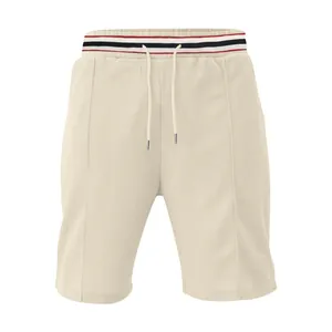 Detail view of men's beige quick-dry breathable sports shorts with striped waistband.