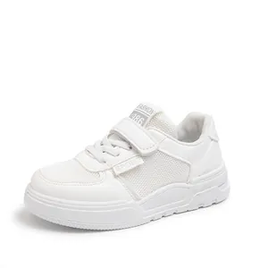 Close-up of stylish white children's casual sneakers with velcro and breathable mesh details