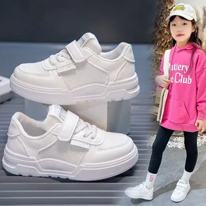 Side view detail of white breathable kids sneakers with soft sole and velcro straps