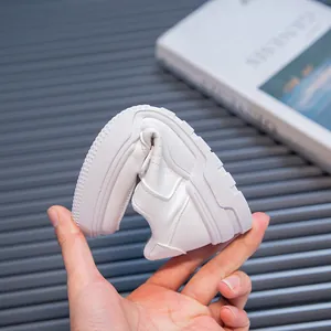 Close-up view showing the highly flexible soft sole of white children's casual sneakers.