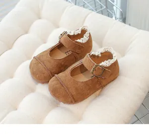 Detailed macro view of brown suede children's shoes with delicate white lace trim