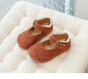 Close-up of brown suede girls' vintage Mary Jane shoes with delicate lace trim