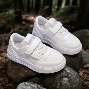 Classic white children's sneakers with soft soles, perfect for casual outdoor play.