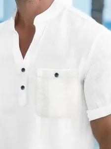 Close-up of white men's short-sleeved Henley shirt with textured pocket detail.