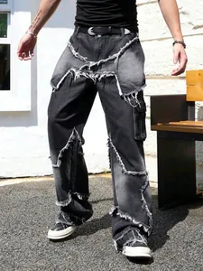 Detail view of distressed patchwork denim jeans with raw edges and street style