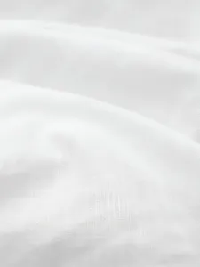 Macro view of breathable white cotton fabric texture for men's polo shirt material