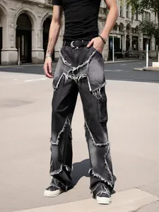 Detailed view of men's high street black denim jeans featuring frayed star patchwork