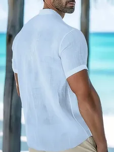Detailed back view of a white textured short sleeve men's casual shirt in a beach setting