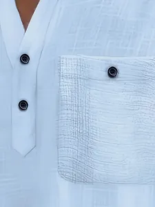 Close-up detail of men's white textured polo shirt featuring black buttons and a chest pocket