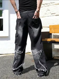 High street style men's distressed black jeans with star patches and frayed edges