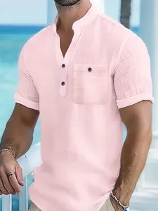 Close-up of pink textured men's polo shirt with chest pocket and mandarin collar.
