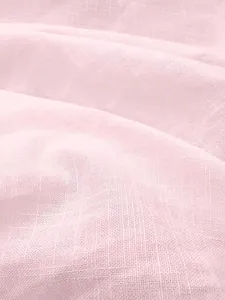 Macro view of light pink breathable linen fabric texture showing detailed weave for summer polo shirt