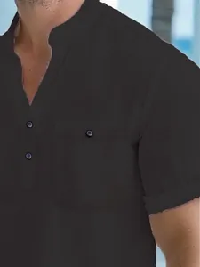 Detail view of a black men's short sleeve polo shirt with half-open collar and pocket