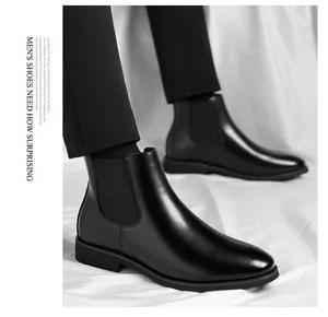 Close-up of black leather Chelsea boots with elastic side panels for men
