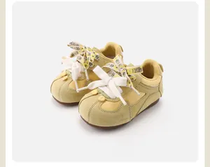 Retro yellow baby walking shoes with floral laces and soft non-slip soles.
