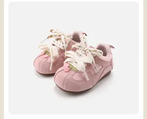 Close-up of pink retro floral toddler walking shoes with soft soles and ribbon laces