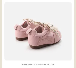 Rear view detail of pink toddler walking shoes with floral ribbon laces and soft soles