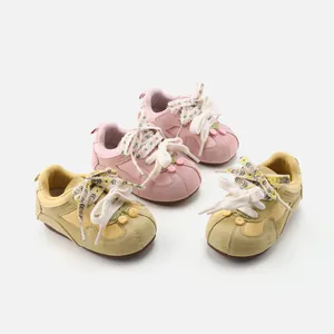 Vintage style baby walking sneakers featuring floral laces and soft soles for toddler girls.