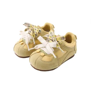 Retro yellow baby walking shoes with soft soles and floral lace design for girls.