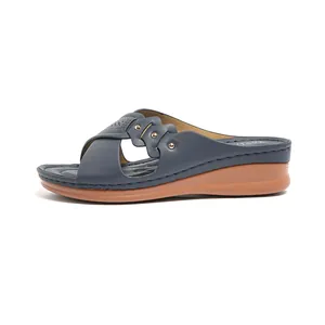 Navy blue women's wedge sandals with perforated crossover straps and comfort sole