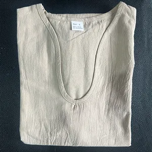 Detail of beige linen V-neck T-shirt showing fabric texture and material tag info