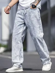 Detail shot of men's loose light blue acid wash straight jeans streetwear style.