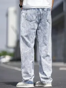 Detail view of men's loose straight-leg acid wash denim jeans from the back view