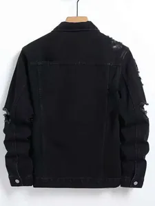 Back view of a black distressed denim jacket with ripped details on sleeves and shoulders