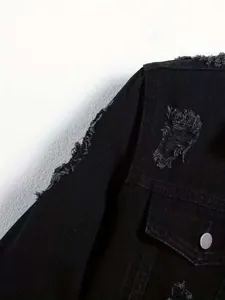Close-up detail of frayed distressed shoulder on black men's denim utility jacket