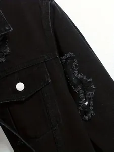 Detailed macro close-up of distressed sleeve and pocket on trendy black denim jacket for men