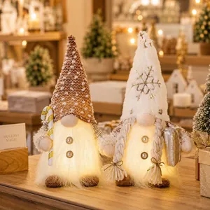 Détail de deux gnomes de Noël lumineux avec LED chaleureuses et accessoires festifs