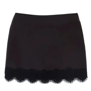 Elegant black mini skort featuring a delicate lace hem detail, isolated on white background.