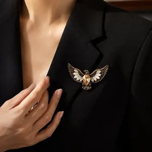 Vintage alloy eagle brooch with amber stone wings pinned on a stylish black blazer lapel