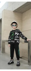 Detailed shot of a child model wearing black and white running shoes with a dial closure