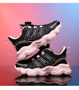 Close-up view of kids black and pink sports sneakers with rotary buckle closure