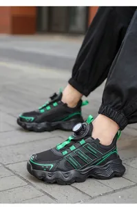Detailed side view of breathable mesh kids' running shoes featuring rotary buckle closure