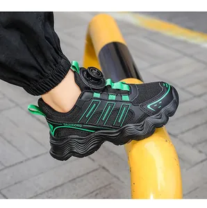 Side detail of kids black and green running shoe featuring innovative rotary dial buckle