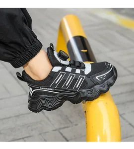 Detailed view of kids' black breathable mesh sneakers featuring a modern rotating buckle.