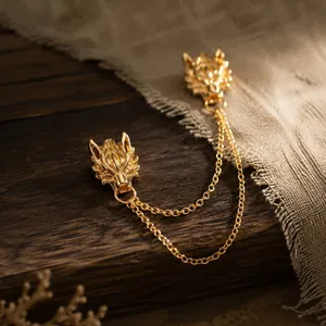 Detailed view of a vintage gold dragon head brooch with elegant double chains