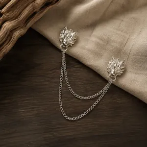 Detailed view of silver dragon head lapel pin with double chains for men's suits