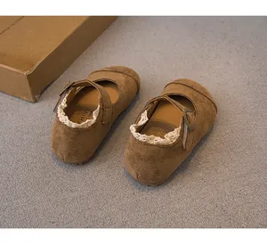Detailed view of brown suede girls' Mary Jane shoes with delicate lace trim and buckle detail