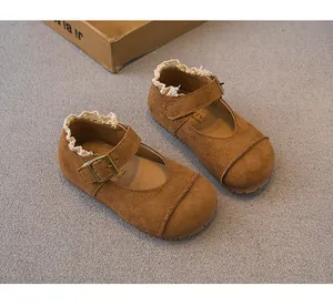 Detailed view of brown suede girls' Mary Jane shoes featuring delicate white lace trim.