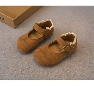 Close-up of brown suede girls' Mary Jane shoes featuring elegant white lace trim