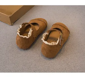 Close-up of brown suede girls' Mary Jane shoes featuring elegant lace trim and metal buckle