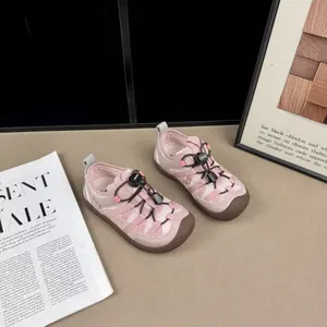 Detail view of pink breathable mesh sneakers for girls featuring easy toggle lace system