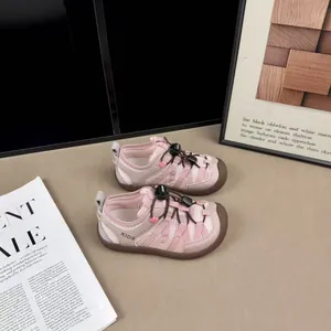 Detail view of pink breathable mesh kids sneakers featuring convenient toggle laces.