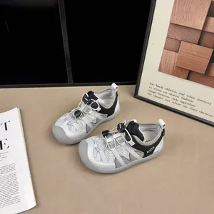 Grey and white breathable mesh sneakers for kids featuring easy adjustable toggles