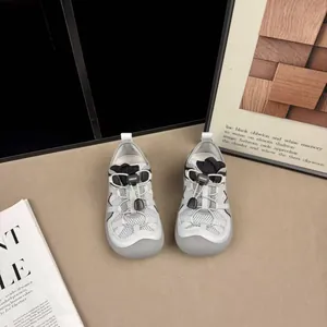 Top view of children's grey breathable mesh sneakers featuring convenient bungee laces