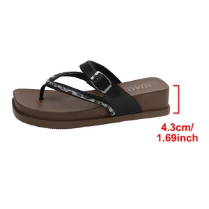 Detail showing the 4.3cm/1.69inch platform height of the brown flip-flops.