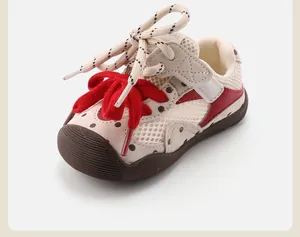 Detailed view of breathable mesh infant walking shoes with decorative red bow